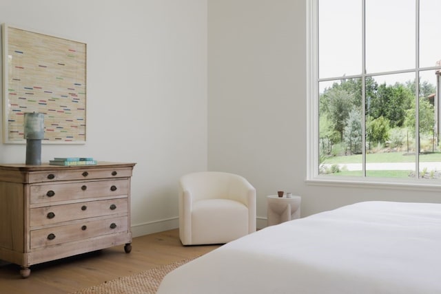 bedroom featuring light wood-style flooring and baseboards