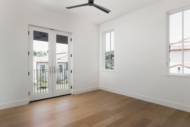 spare room with ceiling fan, baseboards, wood finished floors, and french doors