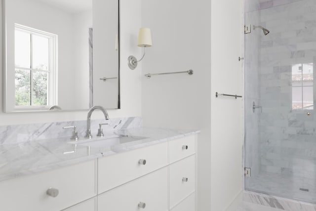 bathroom featuring a shower stall and vanity