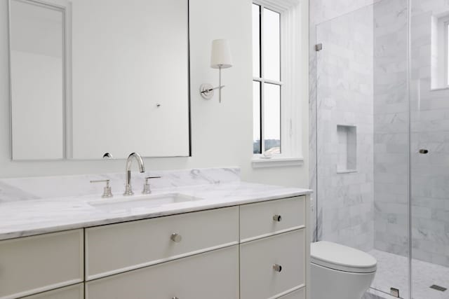 full bathroom with toilet, a shower stall, and vanity