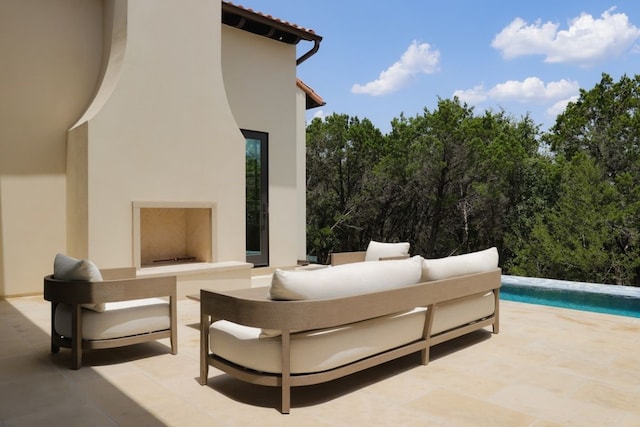 view of patio featuring an outdoor living space with a fireplace and an outdoor pool