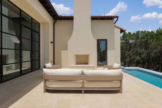 exterior space with a patio area and an outdoor living space with a fireplace