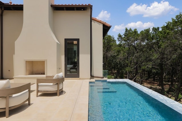 outdoor pool featuring outdoor lounge area and a patio