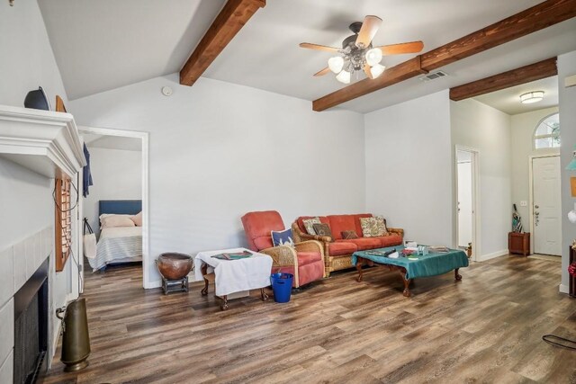 living room featuring vaulted ceiling with beams, wood-type flooring, and ceiling fan