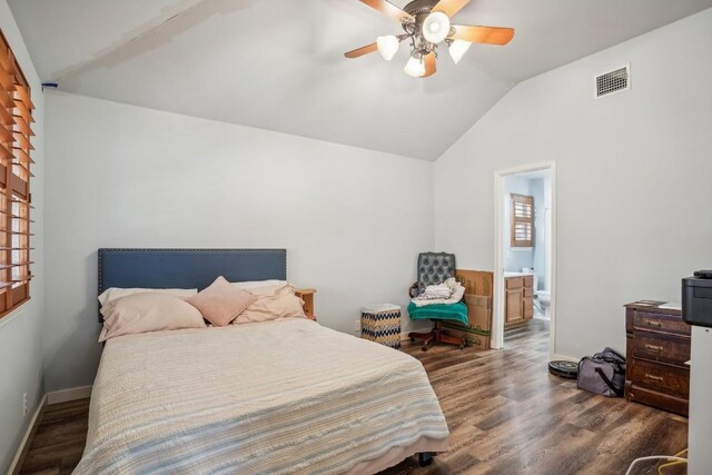 bedroom featuring dark hardwood / wood-style flooring, ensuite bath, vaulted ceiling, and ceiling fan