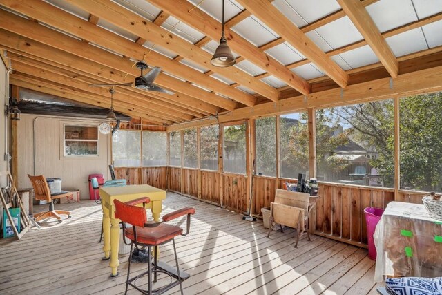 sunroom / solarium with ceiling fan, plenty of natural light, and vaulted ceiling