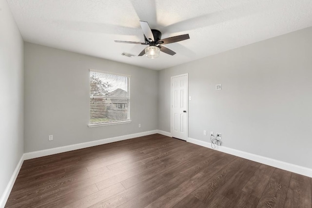 unfurnished room featuring ceiling fan, dark hardwood / wood-style flooring, and a textured ceiling