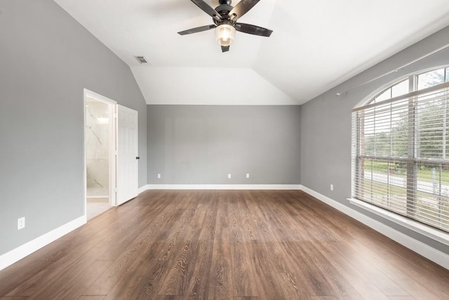 empty room featuring lofted ceiling, ceiling fan, and dark wood-type flooring