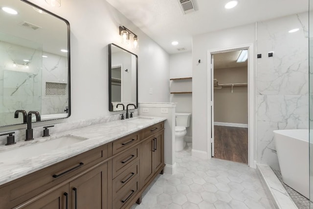 full bathroom with hardwood / wood-style floors, vanity, independent shower and bath, and toilet