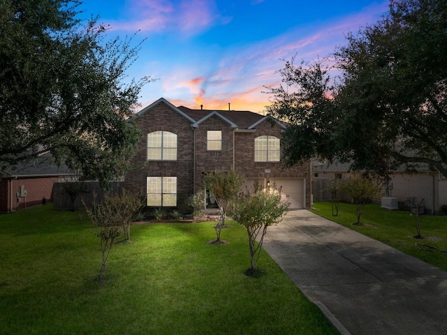 view of front of house featuring a garage and a lawn