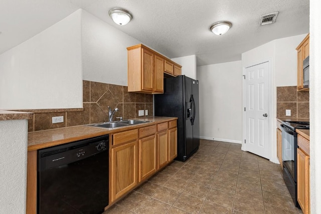 kitchen with tasteful backsplash, sink, black appliances, and a textured ceiling