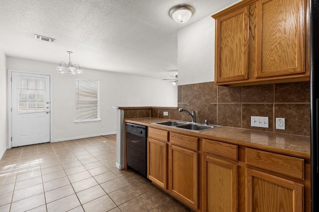 kitchen featuring decorative backsplash, a textured ceiling, sink, light tile patterned floors, and black dishwasher