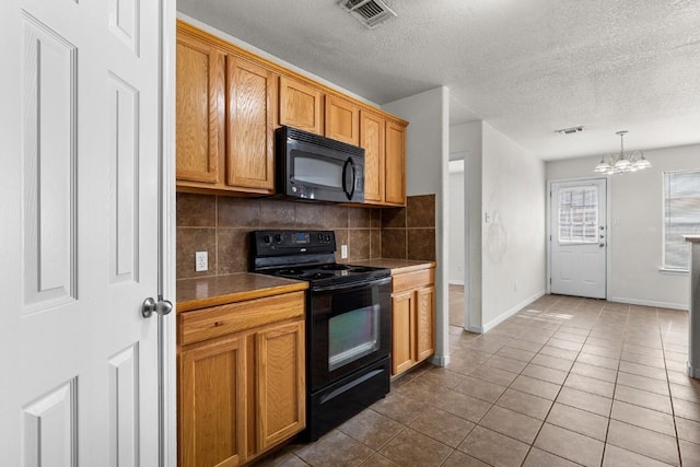 kitchen featuring backsplash, black appliances, decorative light fixtures, tile patterned flooring, and a notable chandelier