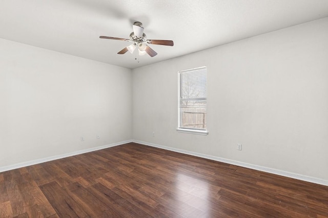 unfurnished room with ceiling fan and dark wood-type flooring