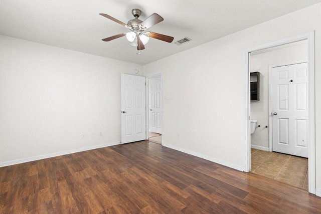 spare room with dark hardwood / wood-style floors and ceiling fan