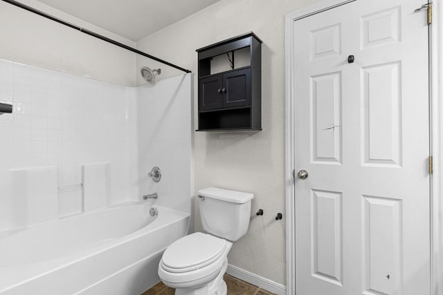 bathroom featuring tile patterned floors, toilet, and bathtub / shower combination