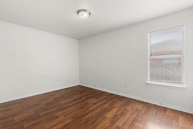 unfurnished room featuring dark hardwood / wood-style floors and plenty of natural light