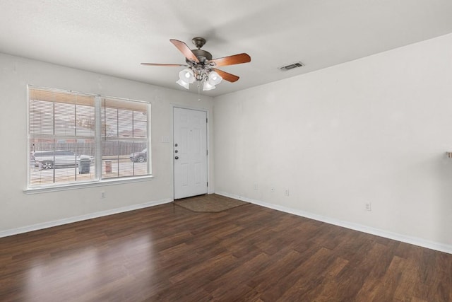 unfurnished room featuring dark hardwood / wood-style floors and ceiling fan