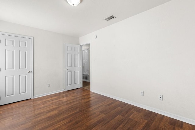 unfurnished bedroom featuring dark wood-type flooring