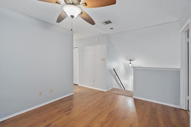 unfurnished living room featuring wood-type flooring and a textured ceiling