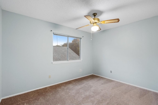 carpeted empty room with ceiling fan and a textured ceiling