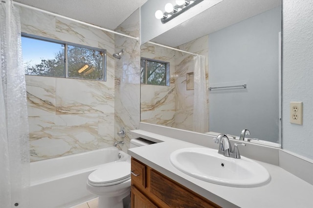 full bathroom featuring shower / tub combo with curtain, vanity, a textured ceiling, and toilet