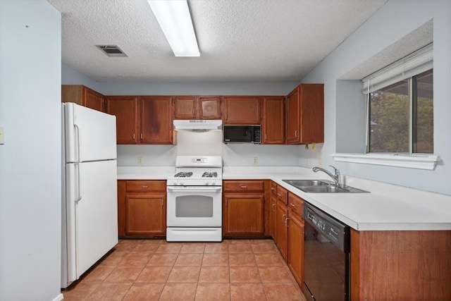 kitchen featuring black appliances, light tile patterned floors, sink, and a textured ceiling