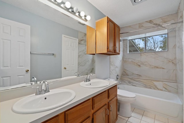 full bathroom featuring tile patterned floors, vanity, a textured ceiling, toilet, and tiled shower / bath