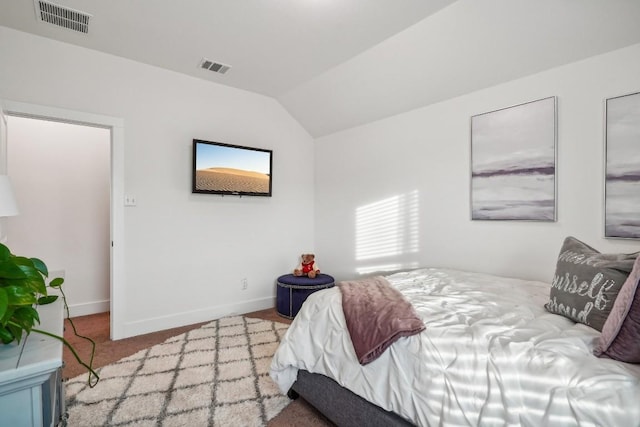 bedroom featuring light carpet and lofted ceiling