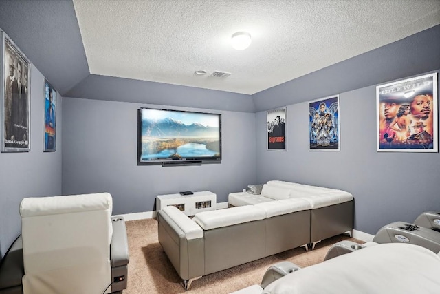 carpeted cinema room featuring a textured ceiling