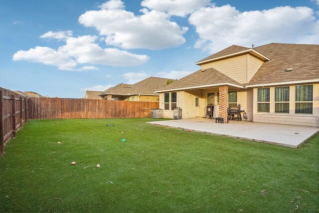 rear view of property featuring a yard and a patio