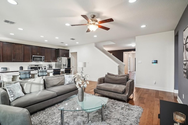 living room featuring ceiling fan and hardwood / wood-style floors