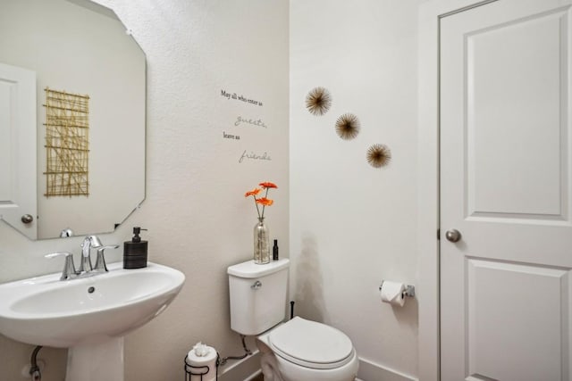 bathroom featuring toilet and sink