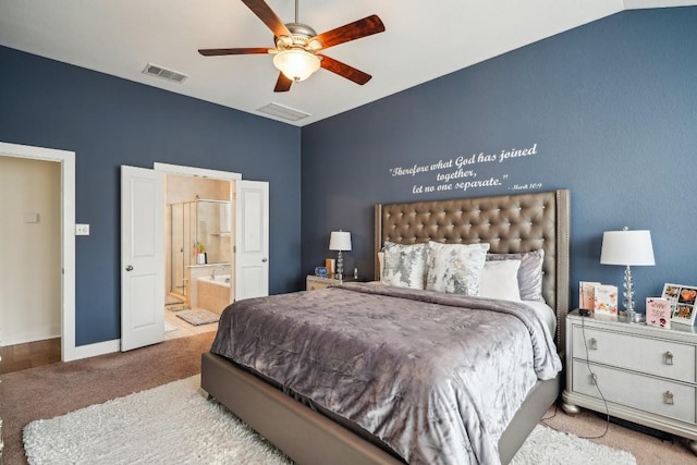 carpeted bedroom with ensuite bath, ceiling fan, and vaulted ceiling