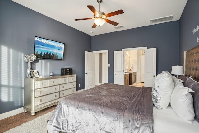 carpeted bedroom featuring ensuite bath and ceiling fan