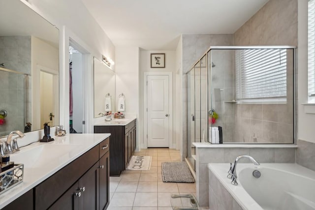 bathroom with tile patterned flooring, vanity, and shower with separate bathtub