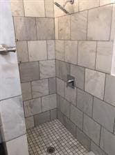 bathroom with tiled shower