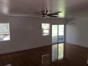 empty room with dark hardwood / wood-style flooring