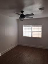 unfurnished room with dark wood-type flooring