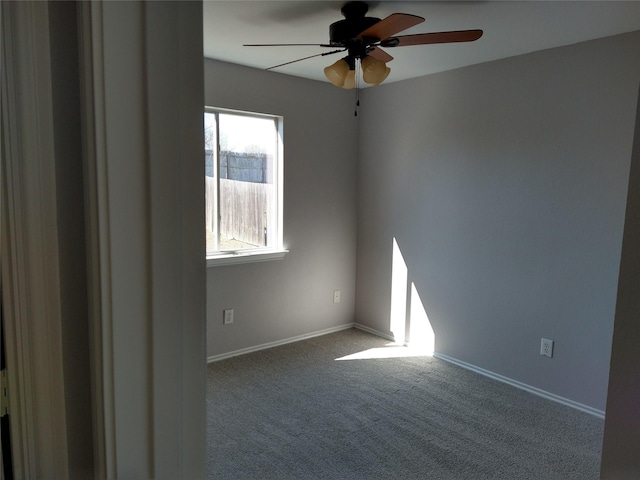 unfurnished room with ceiling fan and carpet flooring