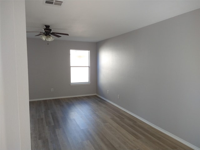 spare room featuring ceiling fan and dark hardwood / wood-style flooring