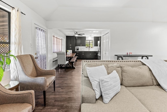 living room featuring dark hardwood / wood-style flooring and ceiling fan