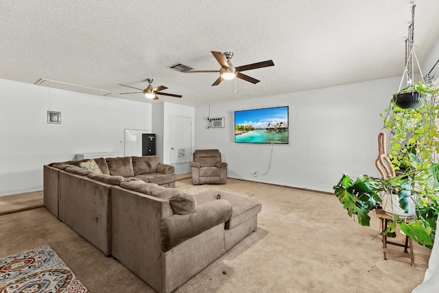 carpeted living room with ceiling fan and a textured ceiling