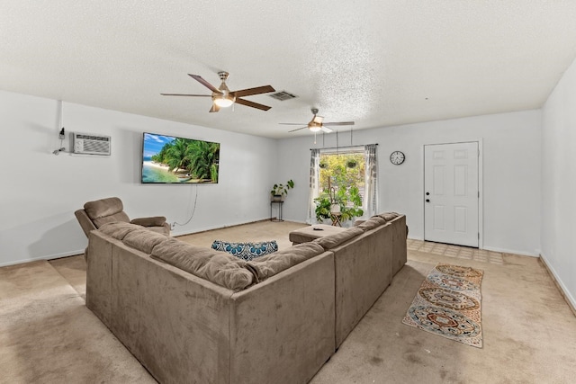 carpeted living room with a wall mounted AC, ceiling fan, and a textured ceiling