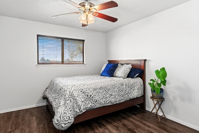 bedroom with dark hardwood / wood-style flooring and ceiling fan