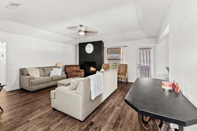 living room with ceiling fan, dark hardwood / wood-style flooring, lofted ceiling, and a fireplace