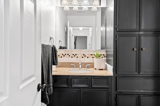 bathroom featuring tasteful backsplash and vanity