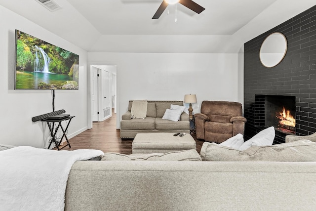 living room with ceiling fan and dark hardwood / wood-style flooring