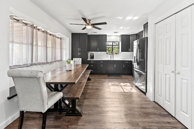 dining space with dark hardwood / wood-style floors, ceiling fan, and sink