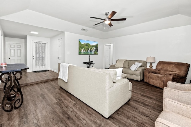 living room featuring ceiling fan, dark wood-type flooring, and vaulted ceiling